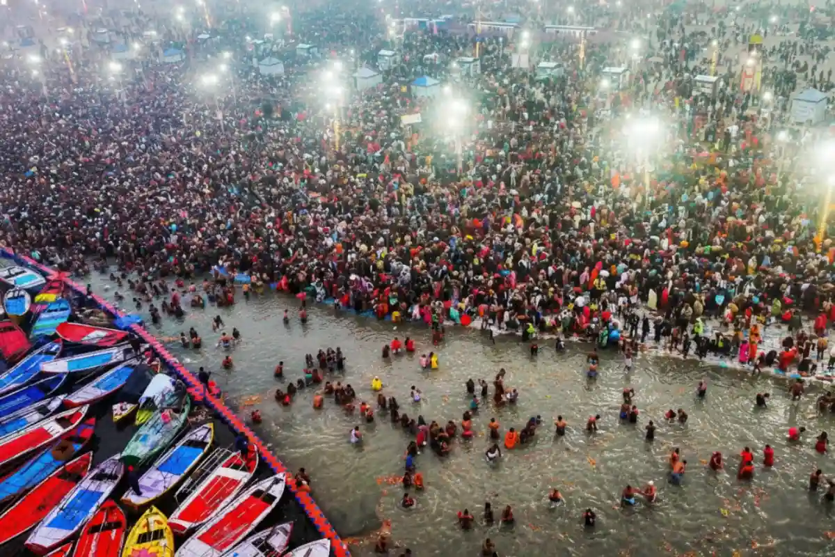 ultra-realistic aerial shot of Triveni Sangam during sunrise, swirling river colors, pilgrims on boats, golden atmosphere.