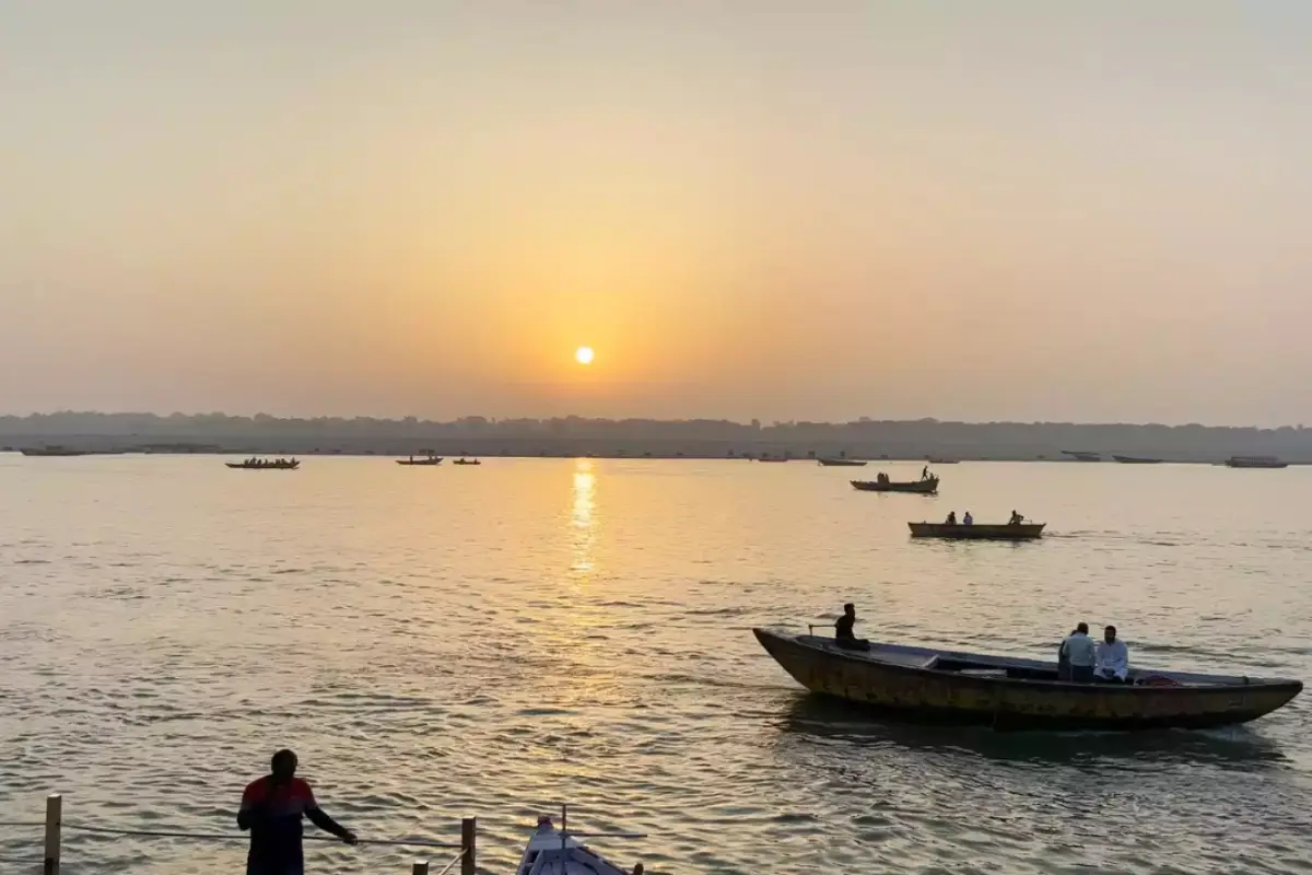 Realistic shot of ancient temples of Prayagraj with early morning light and sacred river reflection.